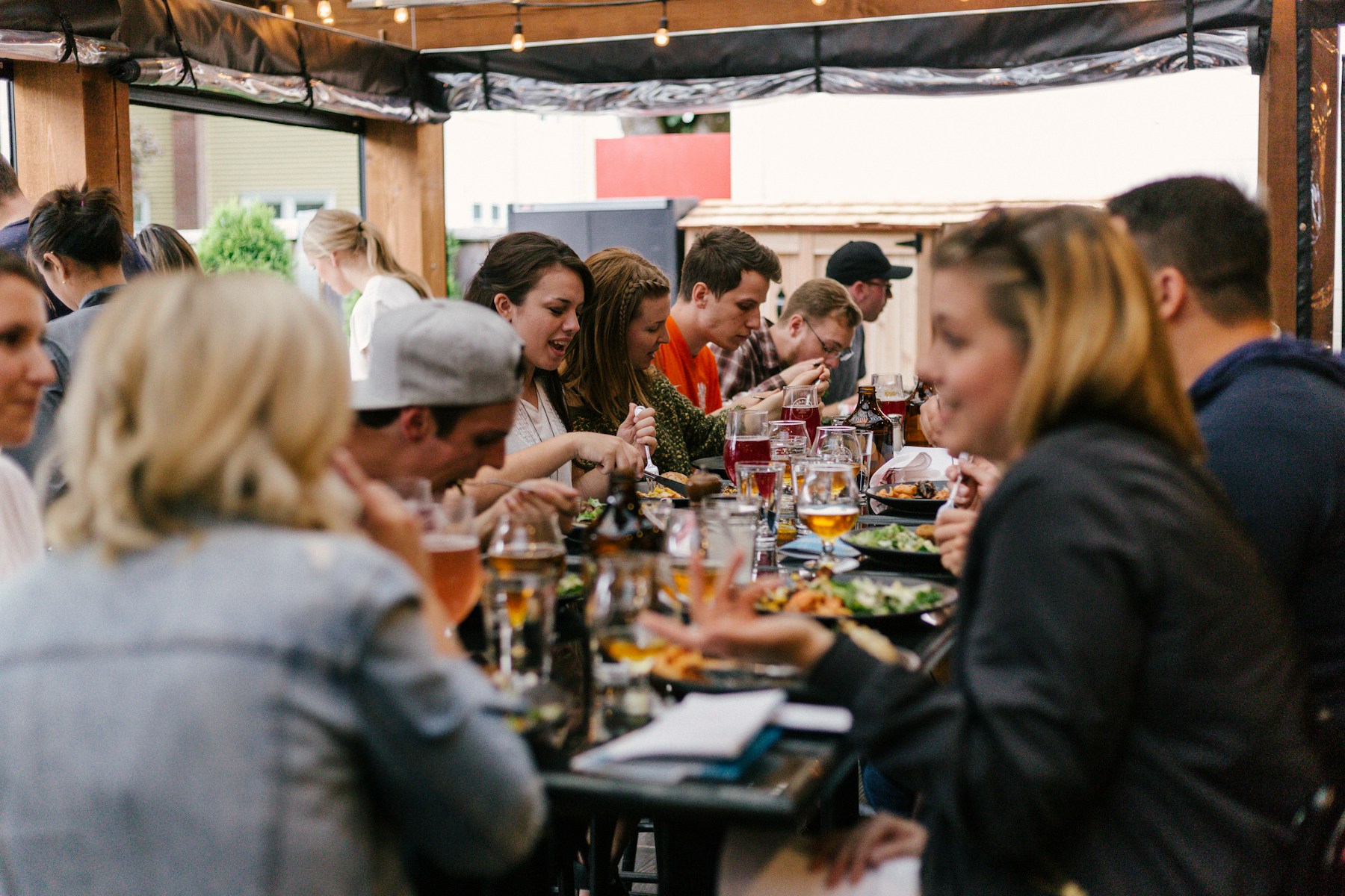 A group gathered around food and drinks