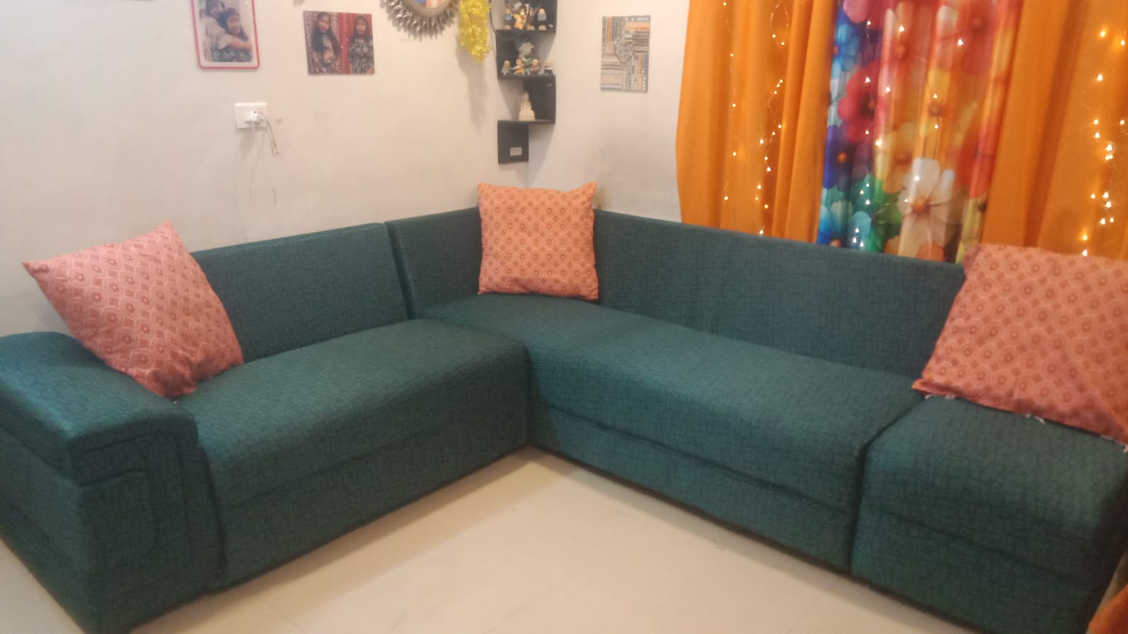 Green corner sofa with contrasting cushions