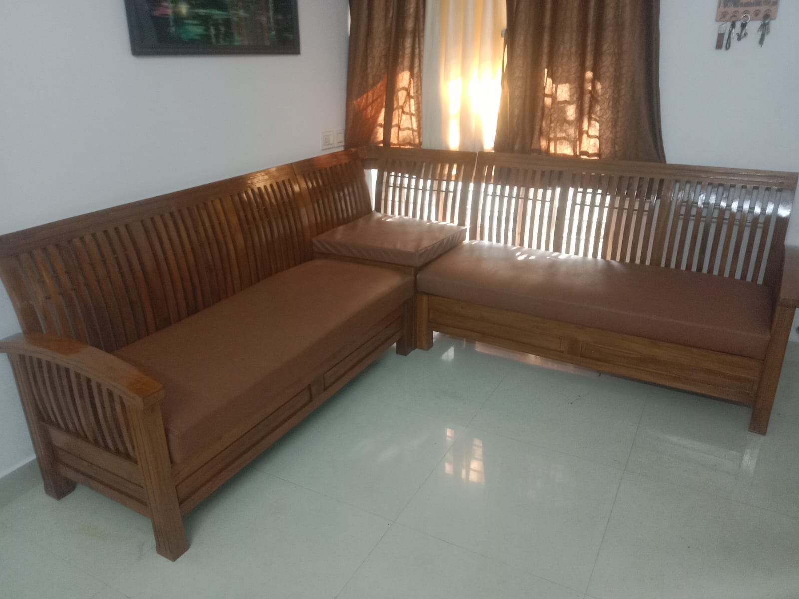 Wooden corner sofa with fitted brown cushions